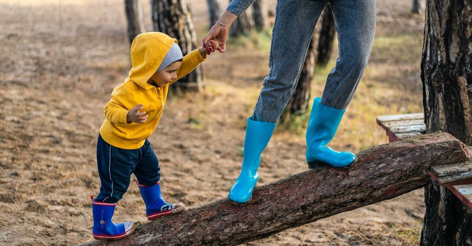 parent helping child climb